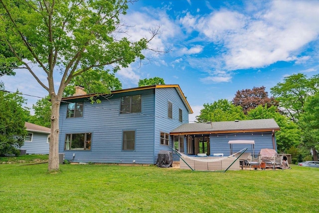 5043 Marathon Dr, Madison, WI 53705 - rear view of house with a chimney and a lawn