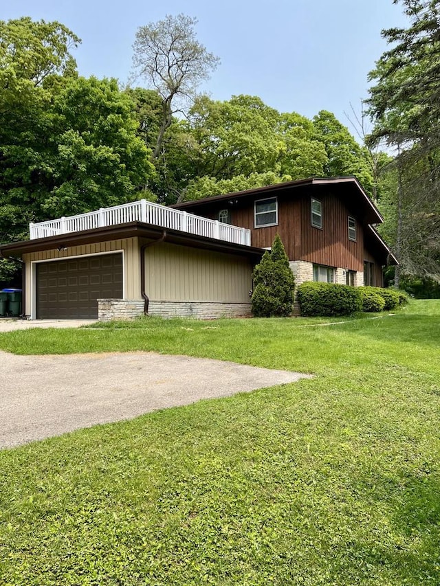 5116 S 84th St, Greendale, WI 53129 - view of front of property with a garage, a front yard, and asphalt driveway
