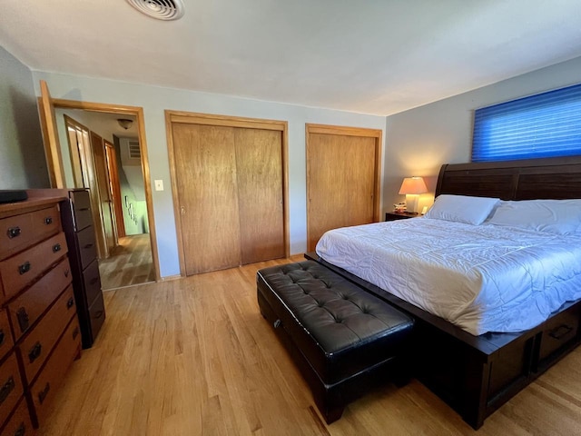 5116 S 84th St, Greendale, WI 53129 - bedroom featuring multiple closets and light wood-style flooring