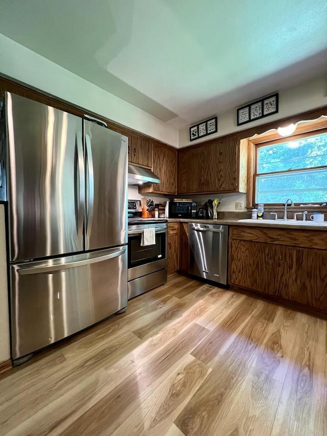 5116 S 84th St, Greendale, WI 53129 - kitchen with stainless steel appliances, under cabinet range hood, and light wood-style flooring