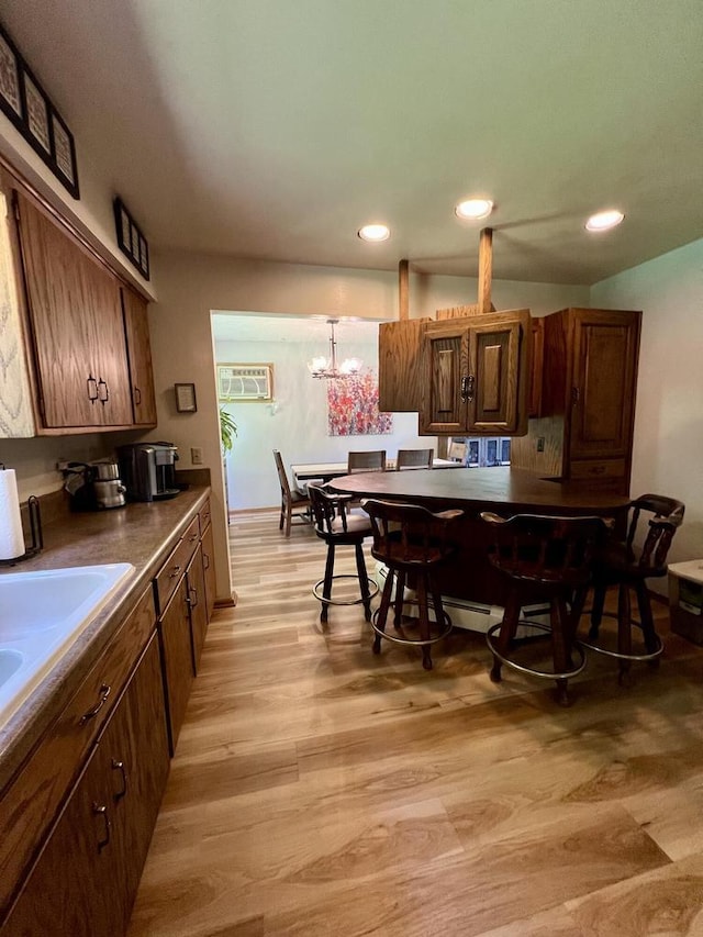 5116 S 84th St, Greendale, WI 53129 - kitchen featuring light wood-style floors, recessed lighting, a chandelier, and dark countertops