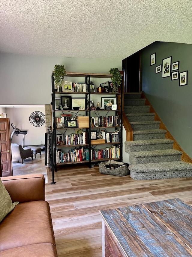 5116 S 84th St, Greendale, WI 53129 - living area featuring wood finished floors, a textured ceiling, and stairway