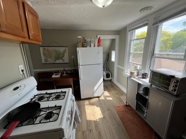 2928 N Humboldt Blvd Unit 2930, Milwaukee, WI 53212 - kitchen featuring white appliances, brown cabinetry, light wood-type flooring, and cooling unit