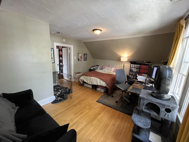 2928 N Humboldt Blvd Unit 2930, Milwaukee, WI 53212 - bedroom with multiple windows, light wood-style flooring, and vaulted ceiling