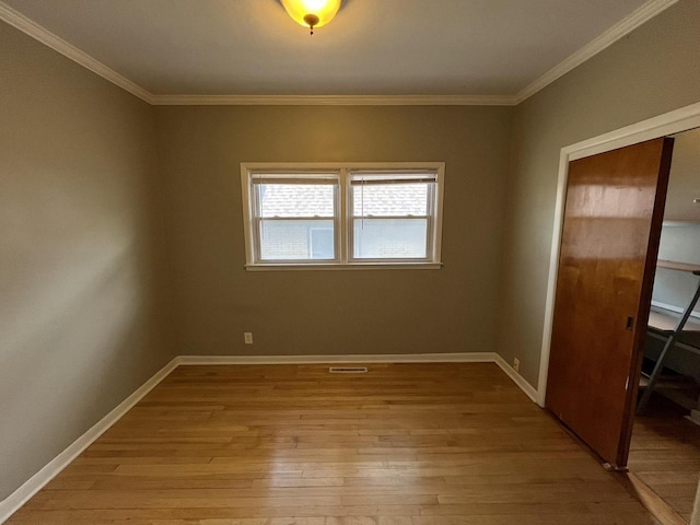 2928 N Humboldt Blvd Unit 2930, Milwaukee, WI 53212 - unfurnished bedroom with light wood-style floors, a closet, and crown molding