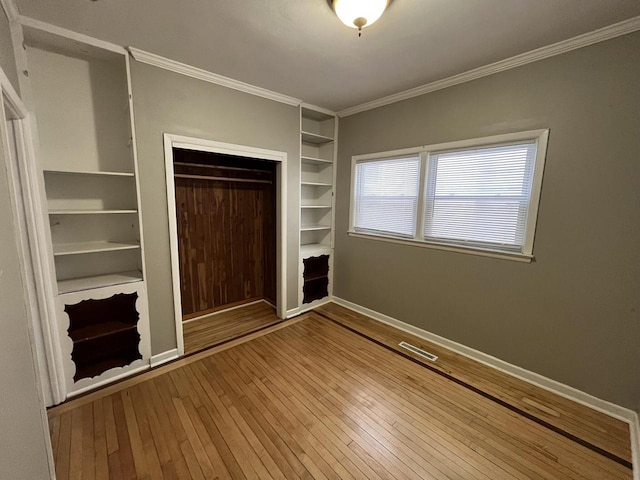 2928 N Humboldt Blvd Unit 2930, Milwaukee, WI 53212 - unfurnished bedroom with wood-type flooring, ornamental molding, and a closet