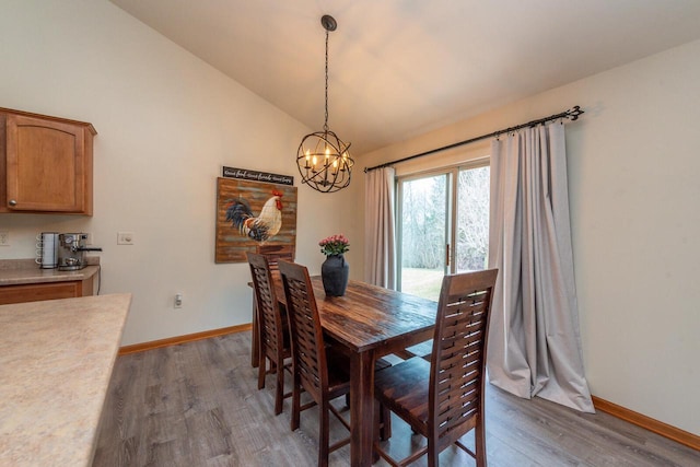 431 Thurow Dr, Oconomowoc, WI 53066 - dining area featuring light wood-style floors, a chandelier, and lofted ceiling