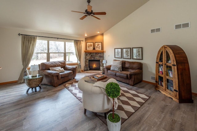 431 Thurow Dr, Oconomowoc, WI 53066 - living area with a ceiling fan, wood finished floors, a stone fireplace, and high vaulted ceiling