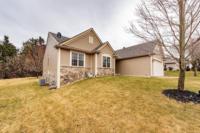 431 Thurow Dr, Oconomowoc, WI 53066 - view of front of property featuring stone siding, a front lawn, a garage, and roof with shingles