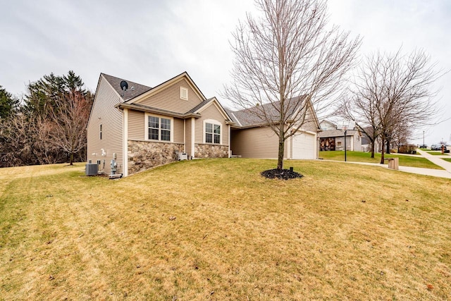 431 Thurow Dr, Oconomowoc, WI 53066 - ranch-style house with stone siding, a front yard, an attached garage, and driveway