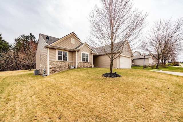 431 Thurow Dr, Oconomowoc, WI 53066 - view of front of home featuring stone siding, a front lawn, and an attached garage