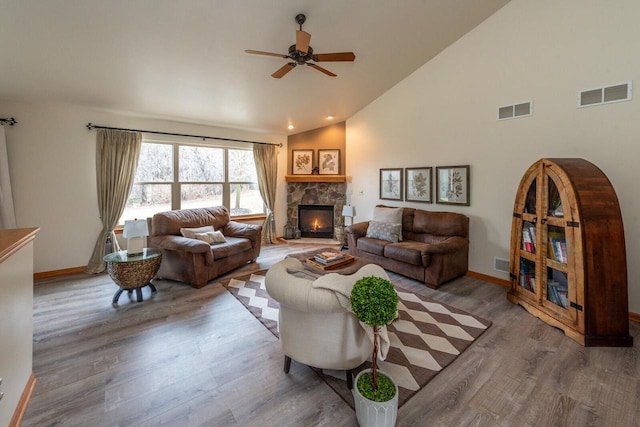 431 Thurow Dr, Oconomowoc, WI 53066 - living area featuring a fireplace, wood finished floors, a ceiling fan, and high vaulted ceiling