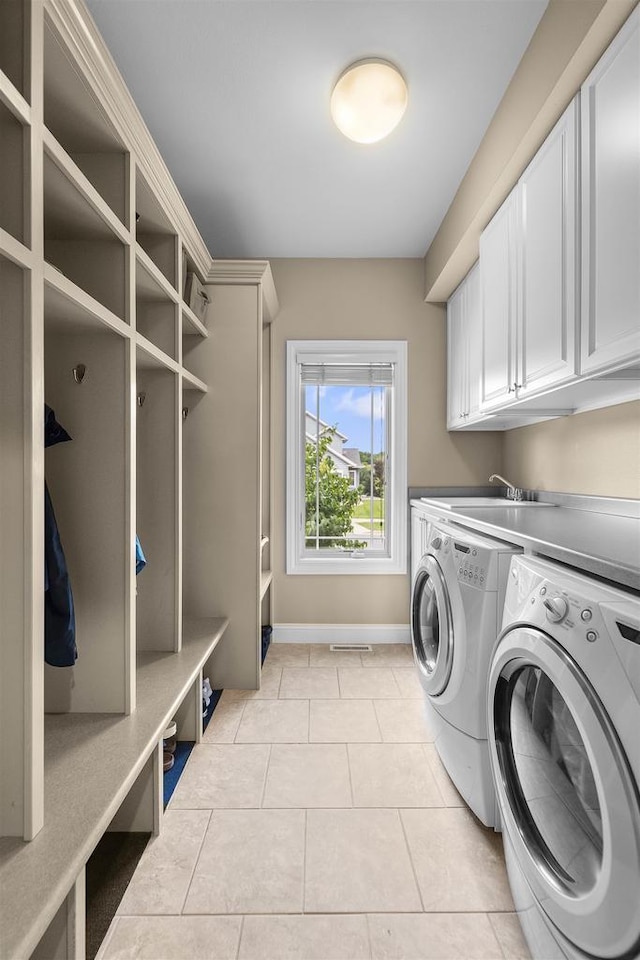 7131 Caneel Trl, Middleton, WI 53562 - laundry area with washer and dryer, cabinet space, and light tile patterned floors