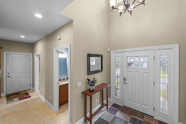 7131 Caneel Trl, Middleton, WI 53562 - foyer featuring a chandelier, a high ceiling, light tile patterned flooring, and recessed lighting