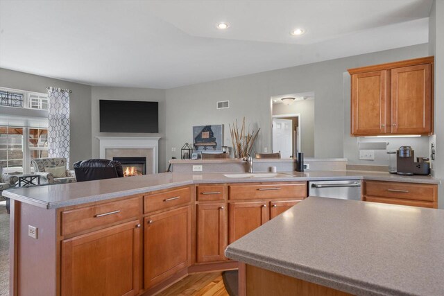 3259 Emmertsen Rd, Racine, WI 53406 - kitchen with dishwasher, open floor plan, a glass covered fireplace, light countertops, and recessed lighting