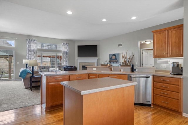 3259 Emmertsen Rd, Racine, WI 53406 - kitchen featuring stainless steel dishwasher, open floor plan, a center island, a fireplace, and recessed lighting