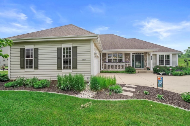 3259 Emmertsen Rd, Racine, WI 53406 - view of front facade with a front yard, an attached garage, concrete driveway, and a shingled roof