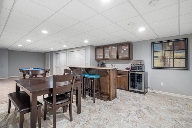 3259 Emmertsen Rd, Racine, WI 53406 - dining area with wine cooler, bar with sink, billiards table, a paneled ceiling, and recessed lighting