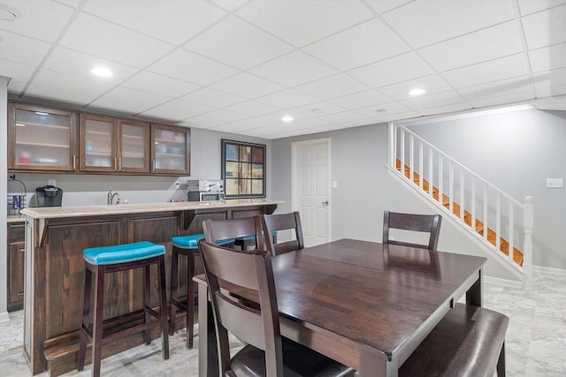 3259 Emmertsen Rd, Racine, WI 53406 - dining area with stairs, a paneled ceiling, recessed lighting, and bar