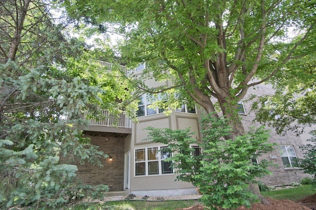 6701 Fairhaven Rd Unit 202, Madison, WI 53719 - rear view of house with brick siding, a balcony, and stucco siding