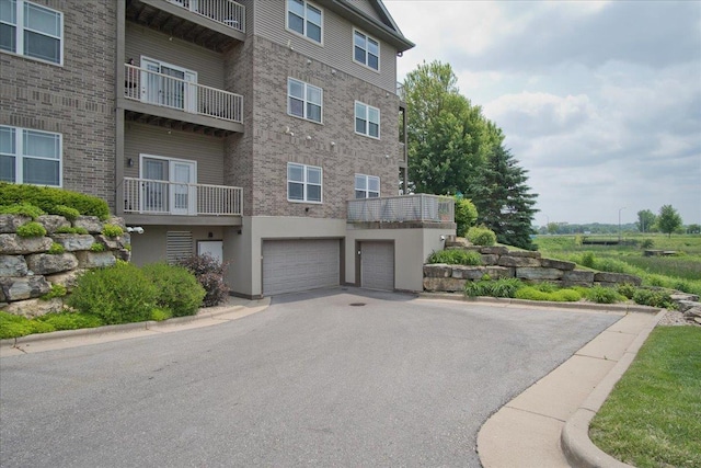 6701 Fairhaven Rd Unit 202, Madison, WI 53719 - view of building exterior featuring asphalt driveway and a garage