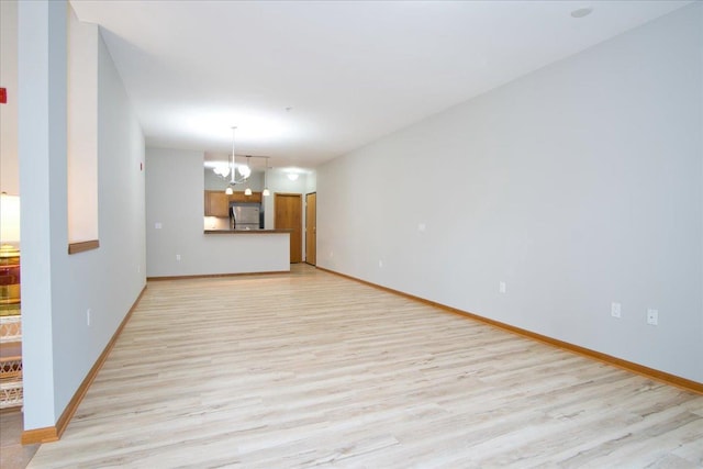 6701 Fairhaven Rd Unit 202, Madison, WI 53719 - unfurnished living room with a chandelier and light wood finished floors