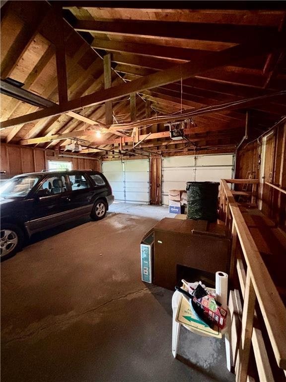 306 Pleasant Ave, Frederic, WI 54837 - garage featuring a garage door opener and wood walls