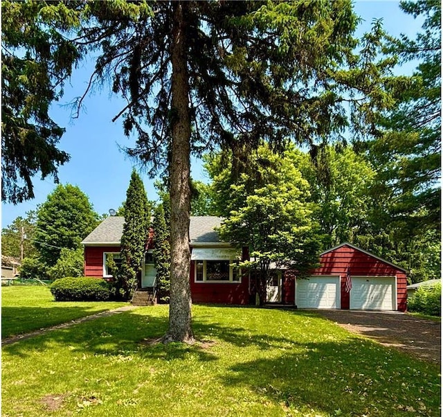 306 Pleasant Ave, Frederic, WI 54837 - obstructed view of property featuring a front lawn and an outbuilding