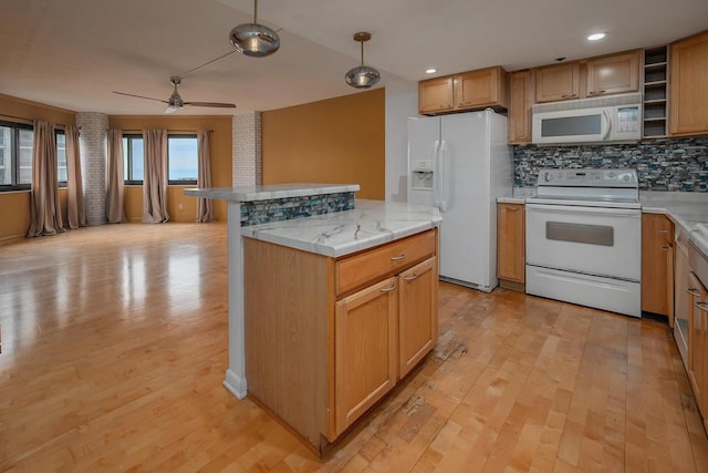 1633 N Prospect Ave Unit 18F, Milwaukee, WI 53202 - kitchen featuring white appliances, tasteful backsplash, light wood-type flooring, light countertops, and recessed lighting