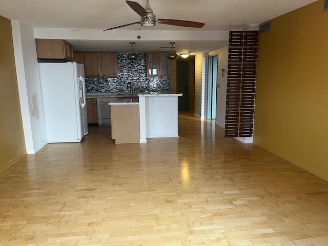 1633 N Prospect Ave Unit 18F, Milwaukee, WI 53202 - kitchen with white refrigerator with ice dispenser, ceiling fan, stainless steel dishwasher, tasteful backsplash, and light wood finished floors