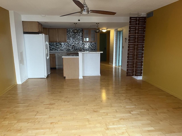 1633 N Prospect Ave Unit 18F, Milwaukee, WI 53202 - kitchen featuring white fridge with ice dispenser, a ceiling fan, dishwasher, backsplash, and light countertops