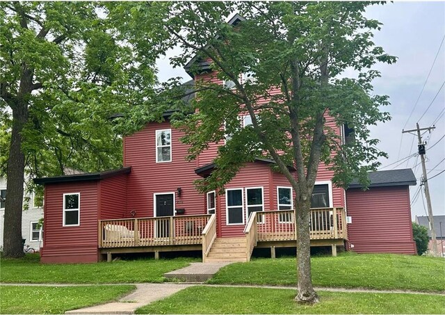 216 E Elm St, River Falls, WI 54022 - rear view of property featuring a deck and a yard