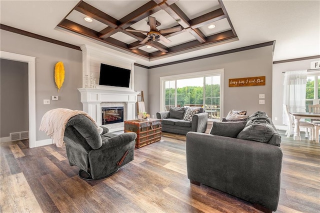 4801 358th St, Stanley, WI 54768 - living area with ceiling fan, crown molding, coffered ceiling, a fireplace, and wood finished floors