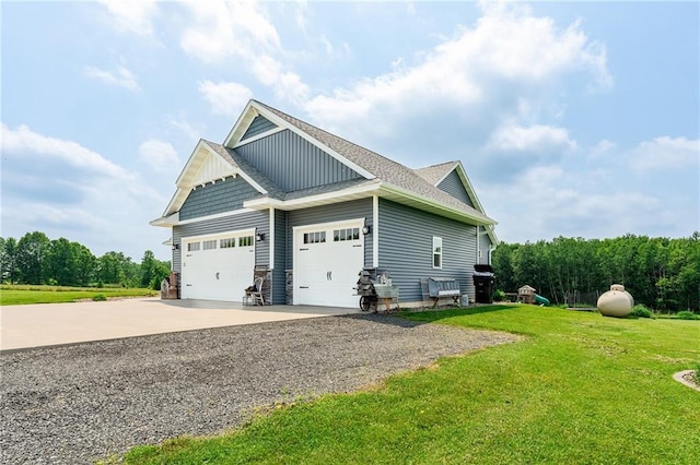 4801 358th St, Stanley, WI 54768 - view of side of property featuring driveway, a yard, an attached garage, a shingled roof, and board and batten siding