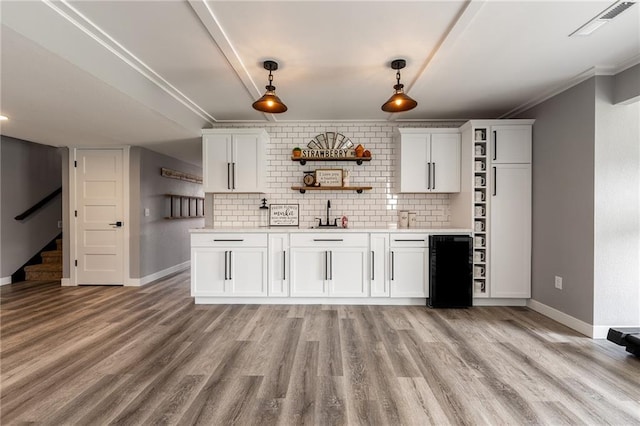 4801 358th St, Stanley, WI 54768 - kitchen featuring open shelves, light countertops, tasteful backsplash, hanging light fixtures, and light wood-type flooring