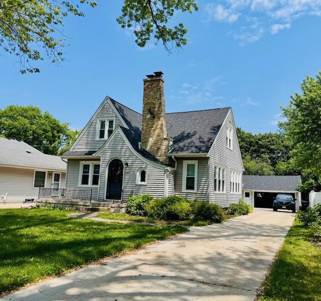 1522 S Sunny Slope Rd, New Berlin, WI 53151 - view of front of property featuring an outbuilding, a chimney, a front yard, a shingled roof, and a garage