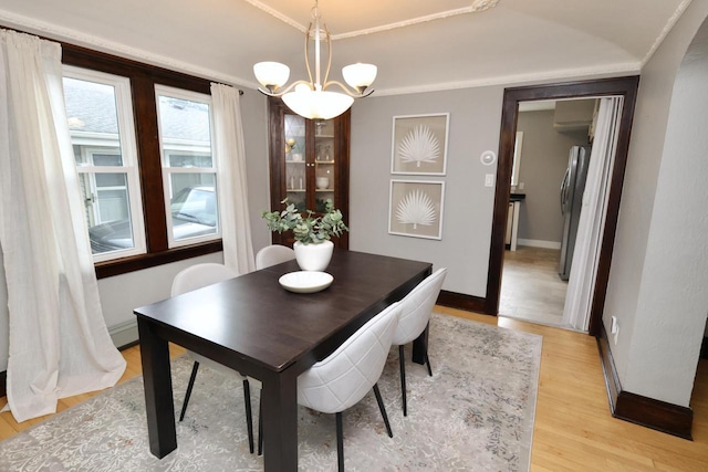 1522 S Sunny Slope Rd, New Berlin, WI 53151 - dining area with a chandelier, light wood-style flooring, and ornamental molding