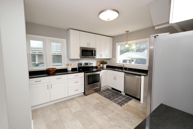 1522 S Sunny Slope Rd, New Berlin, WI 53151 - kitchen featuring stainless steel appliances, white cabinetry, backsplash, and pendant lighting