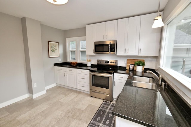 1522 S Sunny Slope Rd, New Berlin, WI 53151 - kitchen with appliances with stainless steel finishes, white cabinets, pendant lighting, and dark stone countertops