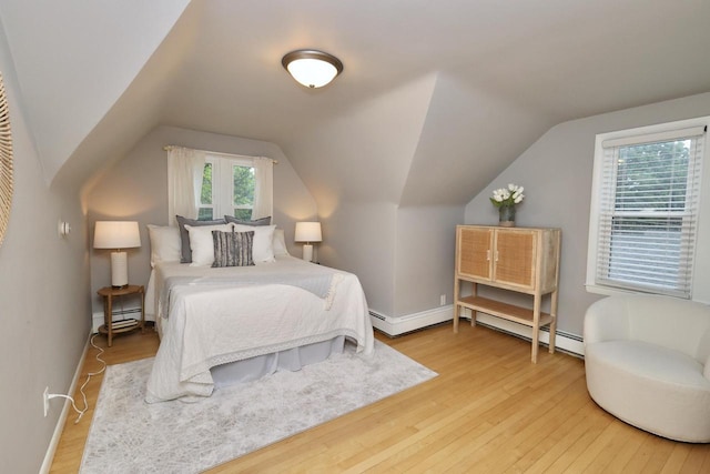 1522 S Sunny Slope Rd, New Berlin, WI 53151 - bedroom with wood finished floors, vaulted ceiling, and a baseboard heating unit