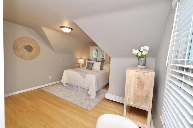 1522 S Sunny Slope Rd, New Berlin, WI 53151 - bedroom with wood finished floors, lofted ceiling, and a baseboard radiator