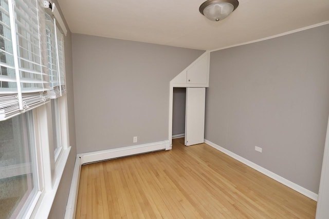 1522 S Sunny Slope Rd, New Berlin, WI 53151 - empty room with a baseboard radiator and light wood-style flooring