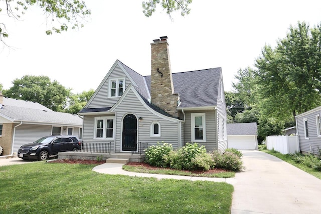 1522 S Sunny Slope Rd, New Berlin, WI 53151 - view of front of property with a chimney, a front lawn, an outbuilding, a garage, and a shingled roof