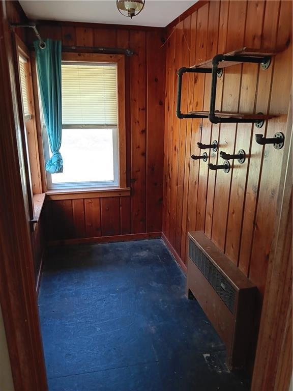 102 E College Ave, Ladysmith, WI 54848 - mudroom featuring wooden walls and radiator heating unit