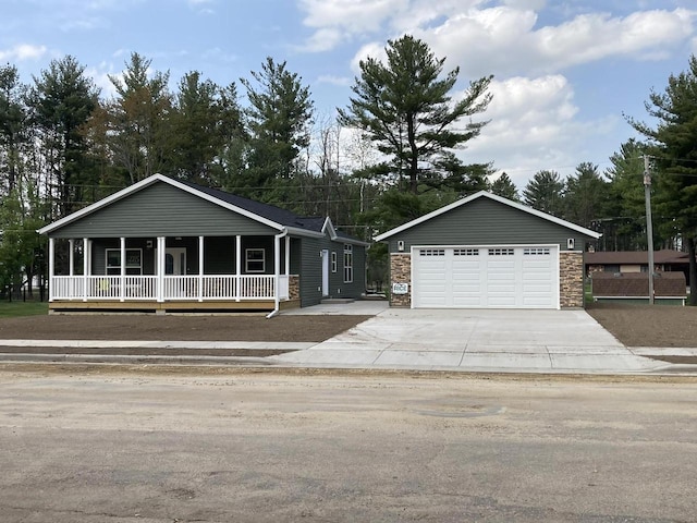 501 View St, Tomah, WI 54660 - view of front of house with a porch, stone siding, and a detached garage