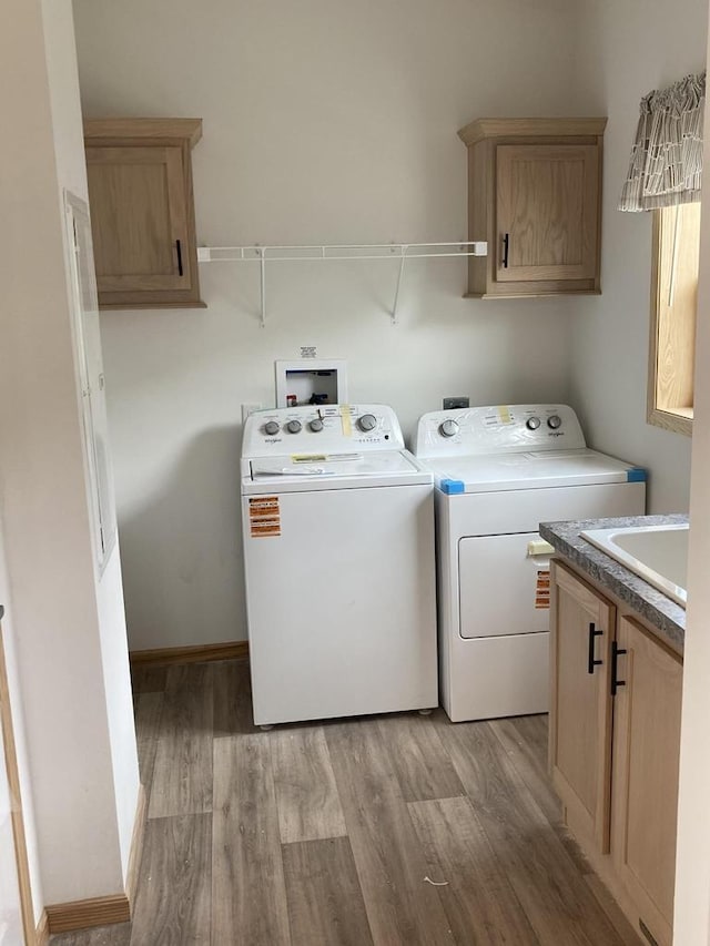 501 View St, Tomah, WI 54660 - washroom with cabinet space, washing machine and dryer, and light wood-type flooring