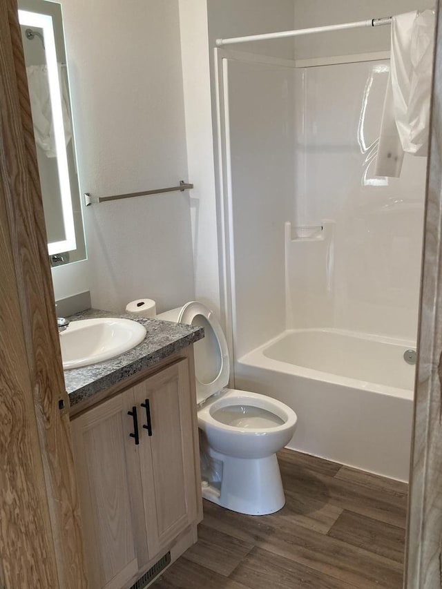 501 View St, Tomah, WI 54660 - bathroom featuring vanity, wood finished floors, and shower / bathtub combination