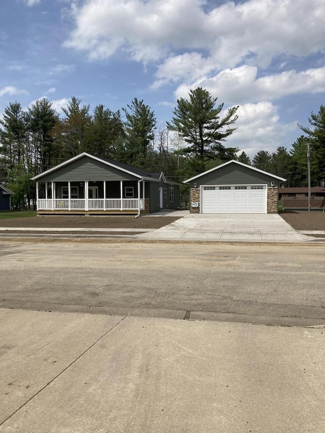 501 View St, Tomah, WI 54660 - view of front of home featuring a porch, a detached garage, an outbuilding, and view of scattered trees