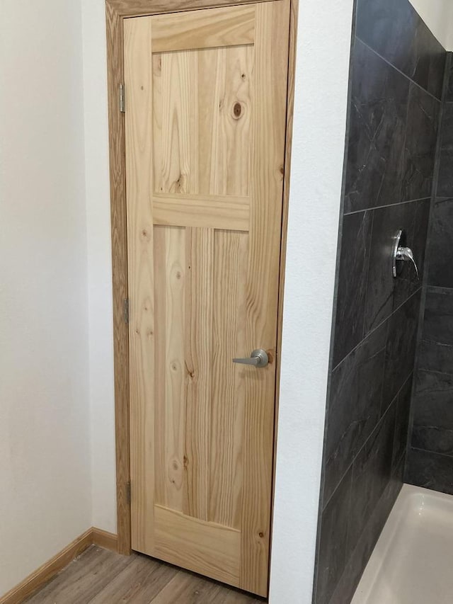 501 View St, Tomah, WI 54660 - bathroom with tiled shower and wood finished floors