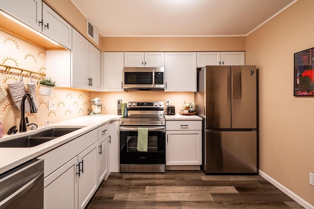 1906 E Shorewood Blvd Unit 250, Shorewood, WI 53211 - kitchen featuring appliances with stainless steel finishes, white cabinets, dark wood-style floors, and crown molding
